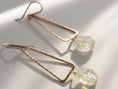 Load image into Gallery viewer, Gold filled citrine dangle earrings worn, featuring triangle shape and organic gemstone texture