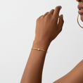 Load image into Gallery viewer, Delicate handmade brass cuff bracelet with opalite stone worn on wrist in natural light, boho minimalist jewelry by bykjones North Carolina