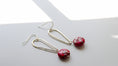 Load image into Gallery viewer, Close-up of elongated silver earrings with pink jasper stones