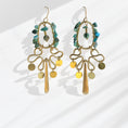 Load image into Gallery viewer, Brass hoop fringe earrings with turquoise stone chips wrapped around oval frame and brass fringe drop — handmade by bykjones