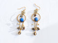 Load image into Gallery viewer, wire-wrapped-mixed-stone-earrings-blue-howlite-sodalite-smokey-quartz-brass-chain-drifter-bykjones