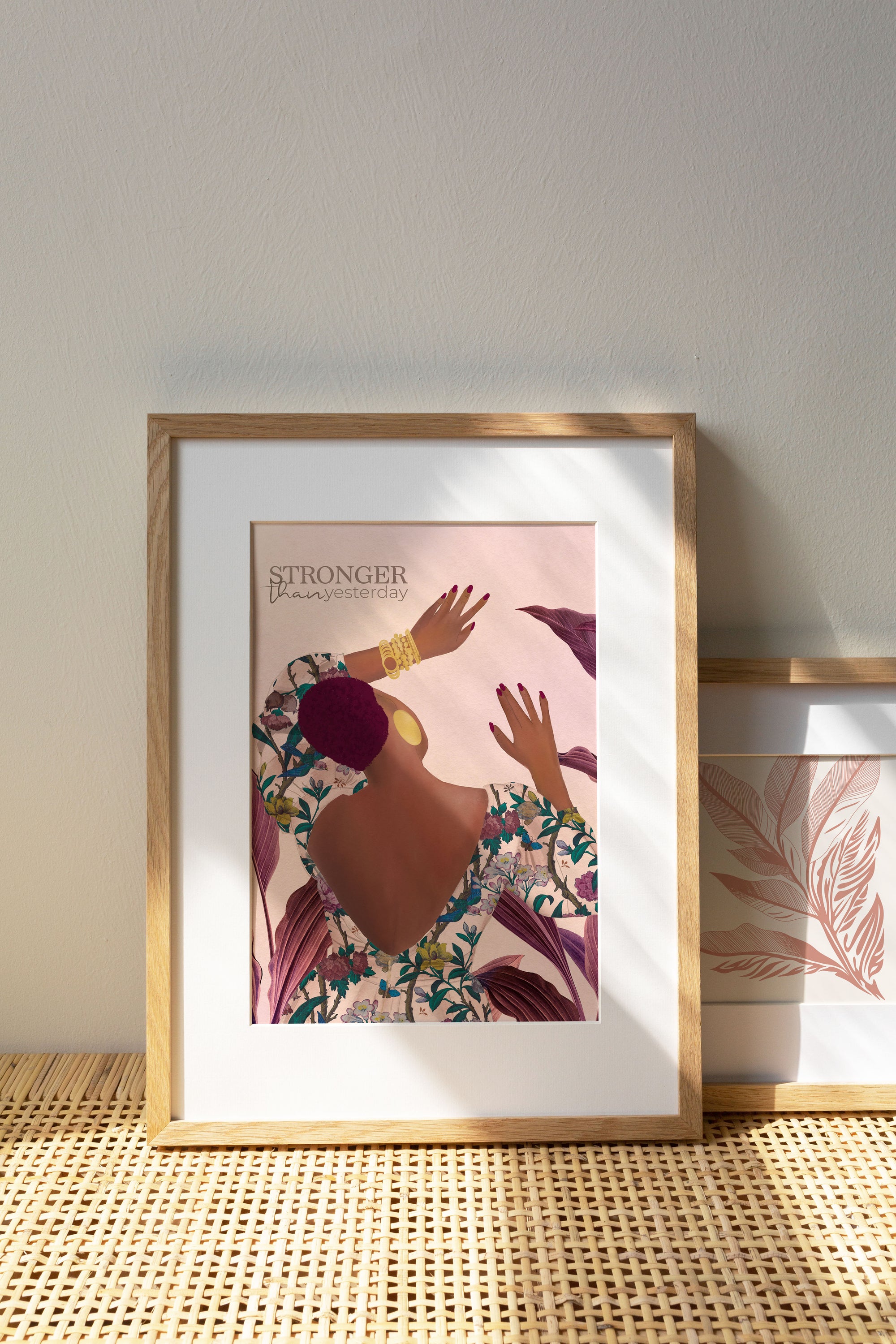 Artwork featuring Tula, a strong black woman in a floral dress, with a serene purple leaves background and the quote "Stronger than Yesterday."