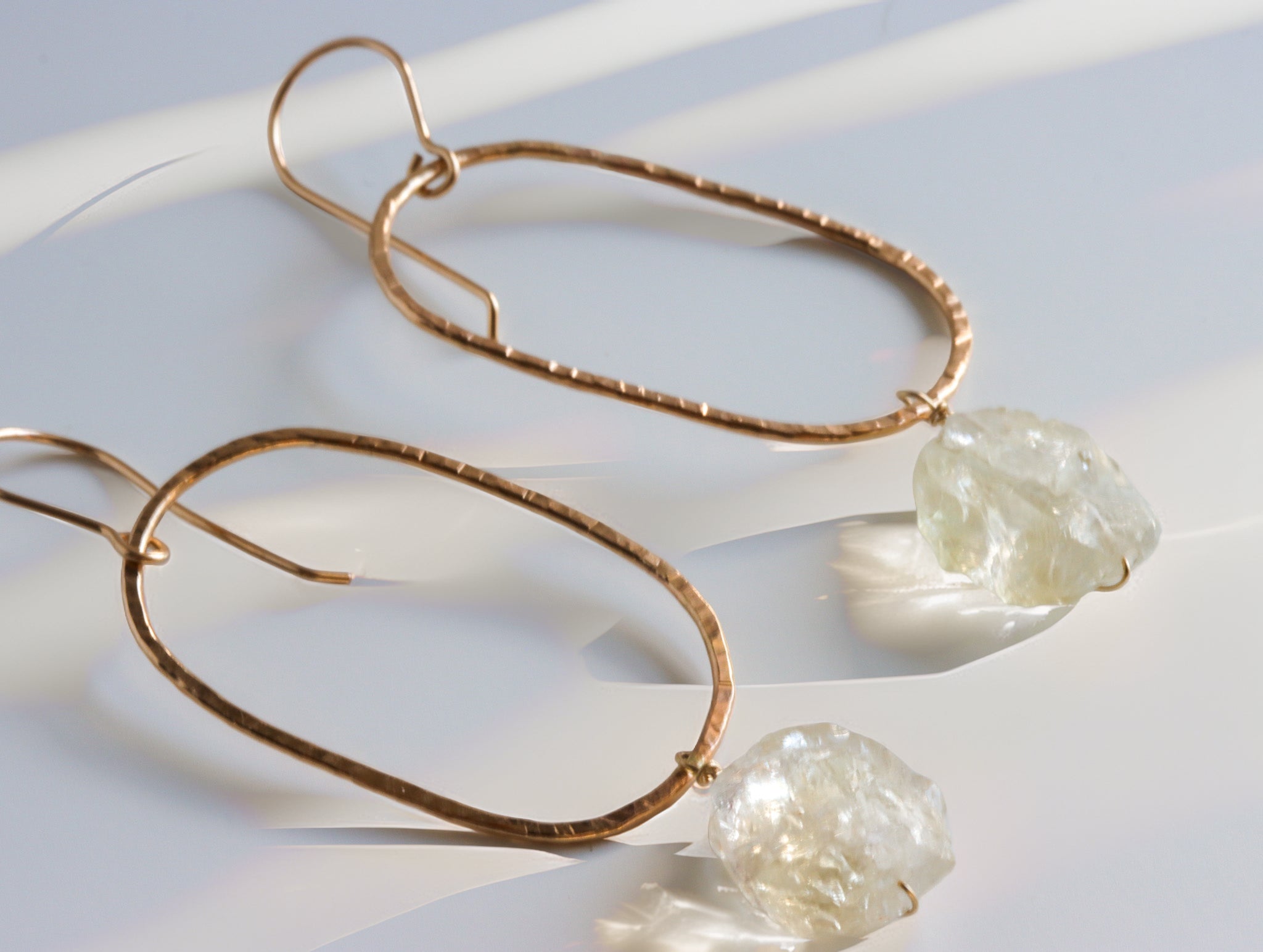 Oval citrine dangle earrings worn, featuring gold filled wire and raw gemstone detail