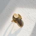 Load image into Gallery viewer, Handmade brass statement ring with mother of pearl and black lip shell cabochons showing light and dark contrast, adjustable boho ring by bykjones NC
