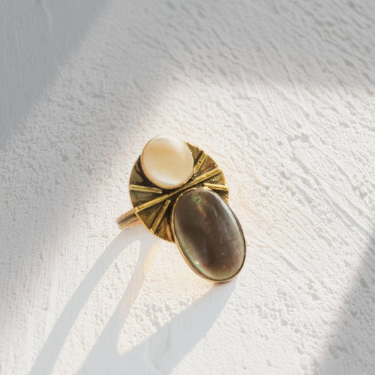 Handmade brass statement ring with mother of pearl and black lip shell cabochons showing light and dark contrast, adjustable boho ring by bykjones NC