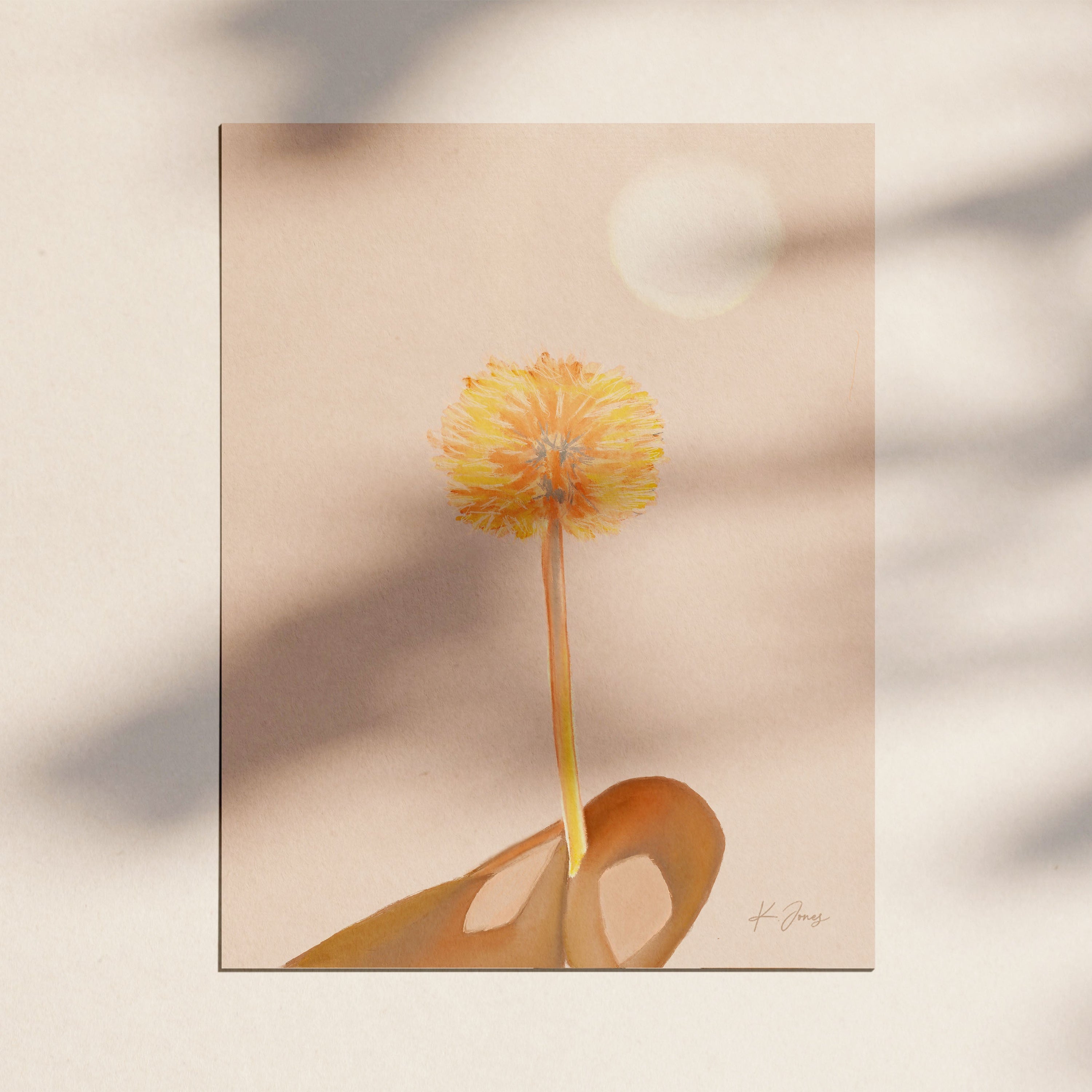 A hand holds a dandelion puff against a cream background, seeds about to float away.