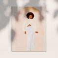 Load image into Gallery viewer, A Black woman in a flowing white dress stands against a golden yellow background.
