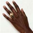 Load image into Gallery viewer, Bold two-stone handmade brass ring with mother of pearl and black lip shell worn on hand, one-of-a-kind statement jewelry by bykjones North Carolina
