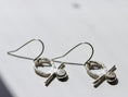 Load image into Gallery viewer, Modern minimalist sterling silver dangle earrings on white textured background
