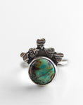 Load image into Gallery viewer, Boho-minimalist silver ring adorned with heart motifs and blue-green African Turquoise, handcrafted statement piece.
