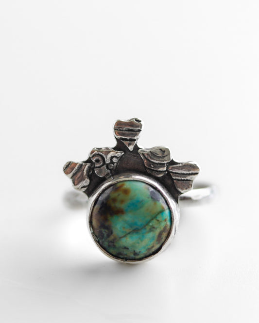 Boho-minimalist silver ring adorned with heart motifs and blue-green African Turquoise, handcrafted statement piece.
