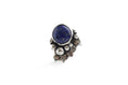 Load image into Gallery viewer, Boho-minimalist sterling silver ring with vivid lapis lazuli center and sculptural stamped embellishments, handcrafted statement piece.
