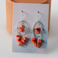 Load image into Gallery viewer, Pair of large sterling silver dangle earrings with pink coral gemstones, combining 2.5 inches of bohemian elegance with calming energy.
