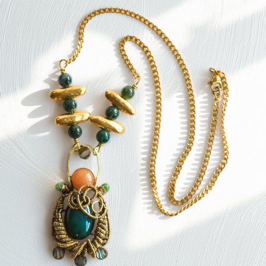 Full handmade statement necklace with wire woven brass pendant, red aventurine, dark green jade, jade bead chain and brass accents, flat lay by bykjones NC jewelry artist